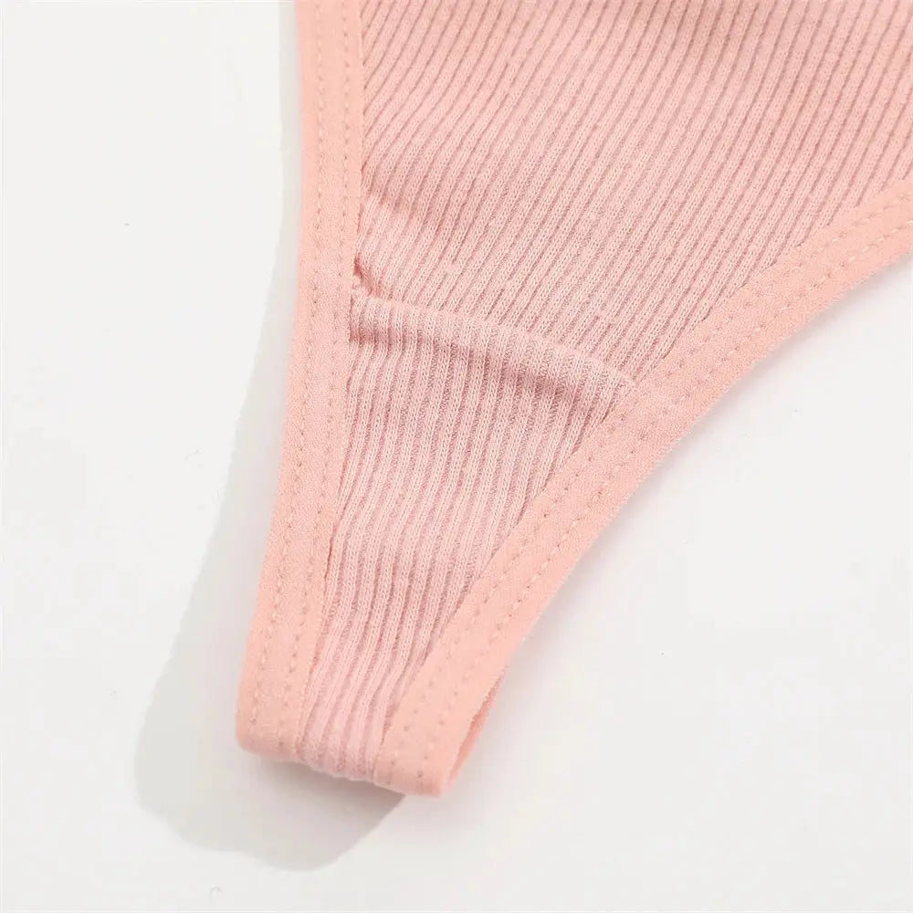 Soft pink ribbed cotton thong underwear for women, breathable fabric.