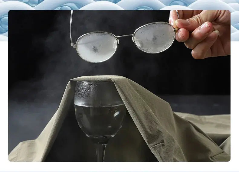 Camping gear: beige tent, stemmed wine glass inside, and sunglasses held overhead.