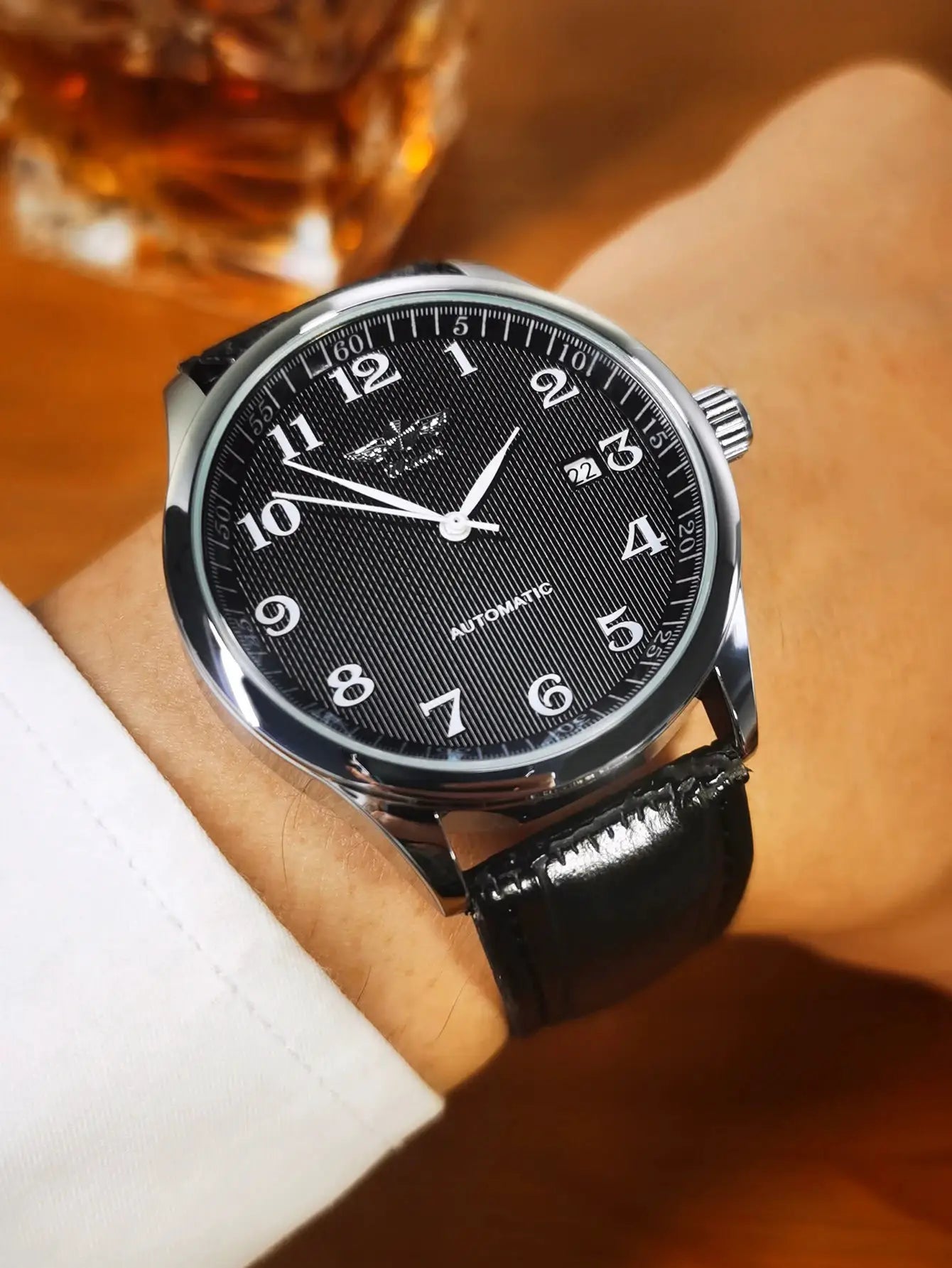 WINNER automatic men's watch with black textured dial, silver case, date window, and black leather strap