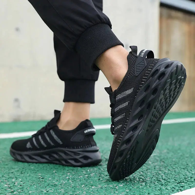 Unisex black knit running sneakers pair with striped side panels and hollow-out outsole.