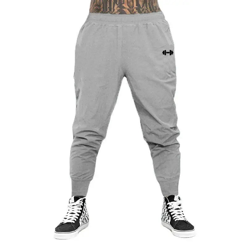 Men's grey gym jogger pants with elastic waist and cuffed ankles, dumbbell logo
