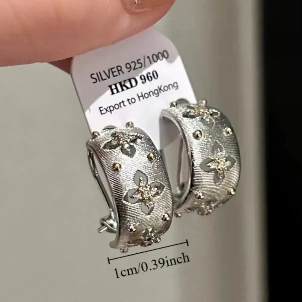 Silver hollow flower hoop earrings with inlaid zircon; 1 cm diameter, silver-tone metal