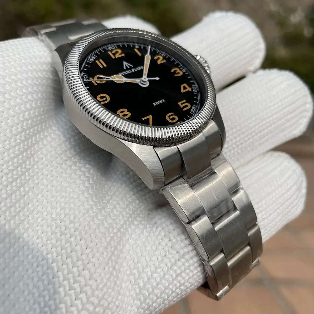 STEELFLIER SF741 wristwatch with stainless steel bracelet, black dial with gold numerals, 200m water resistance