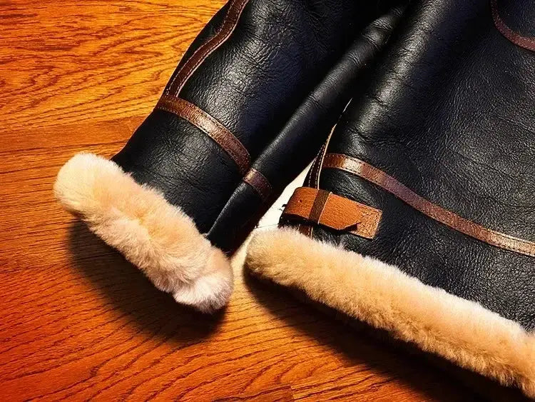 Men's shearling leather coat in black with fur-trimmed cuffs and hem, belt detail