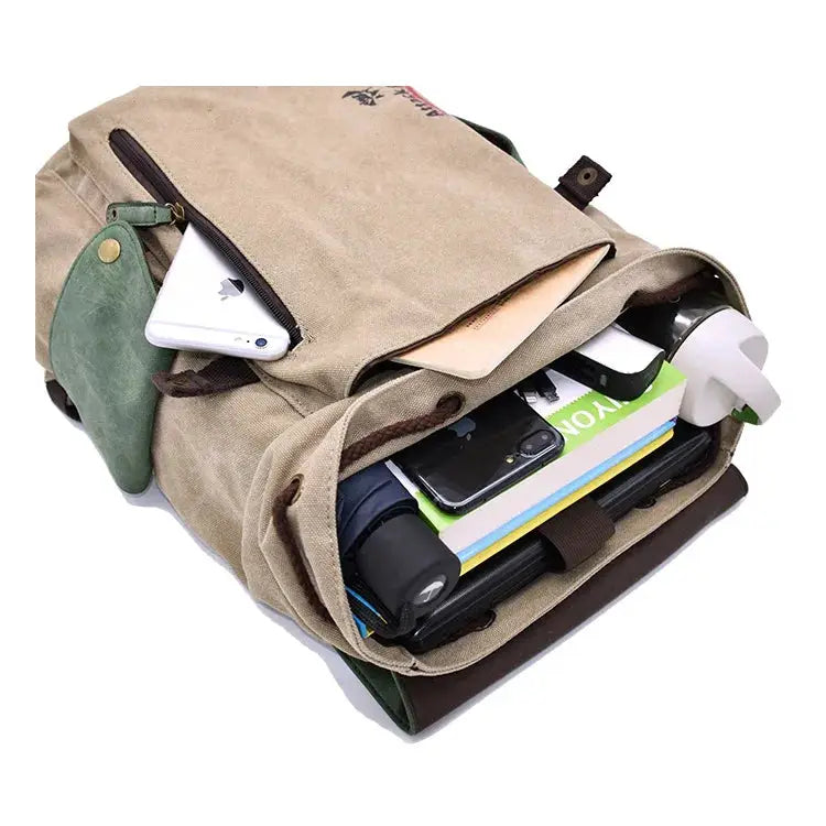 Beige canvas backpack by Simples Market with front zipper, packed with 3 items: phone, books, water bottle
