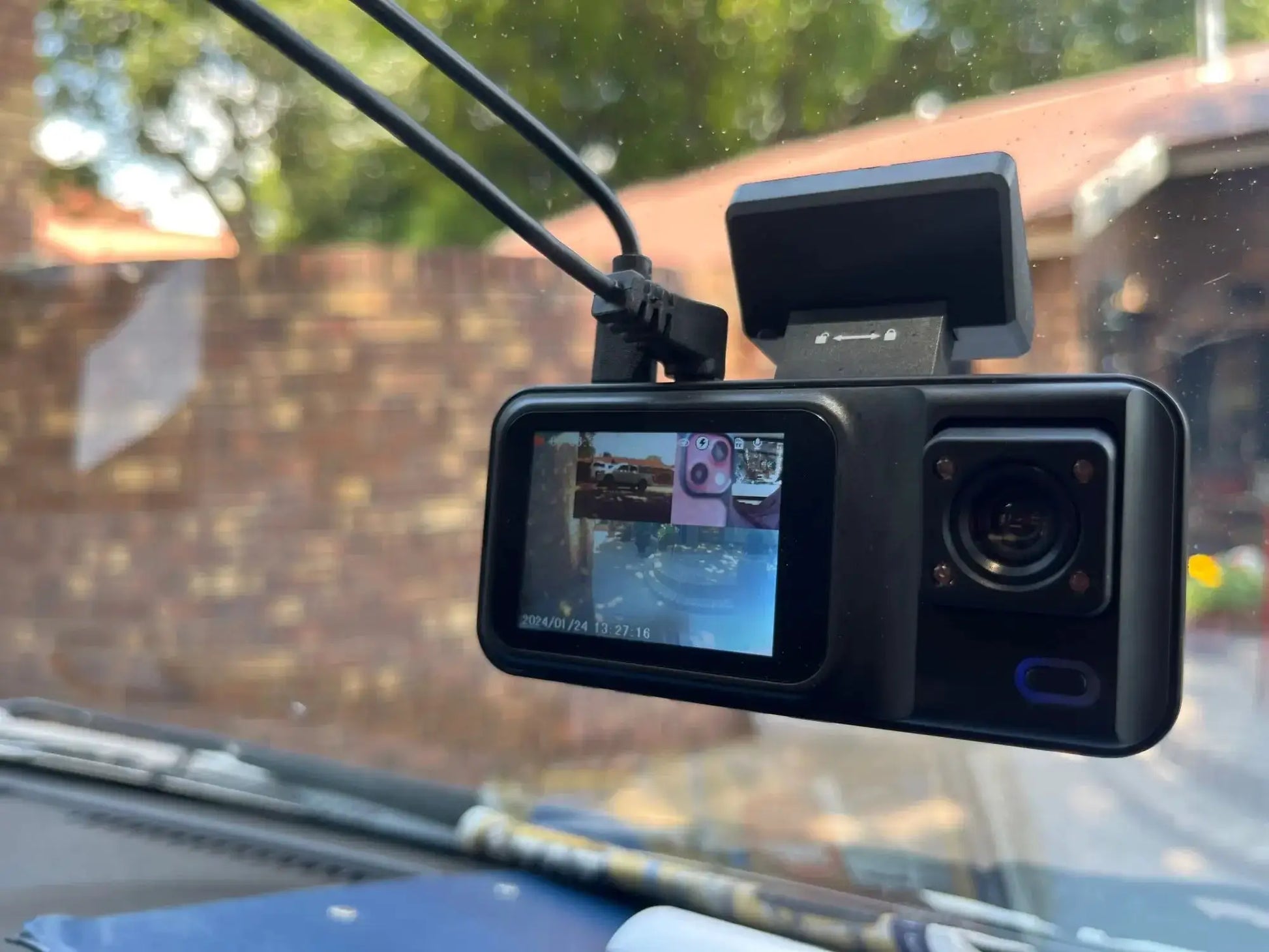 3-channel car dash cam in black with built-in LCD screen and windshield mount