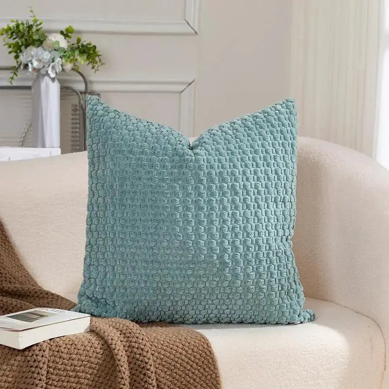 Soft velvet double-sided cushion cover in teal on a white sofa, by Simples Market