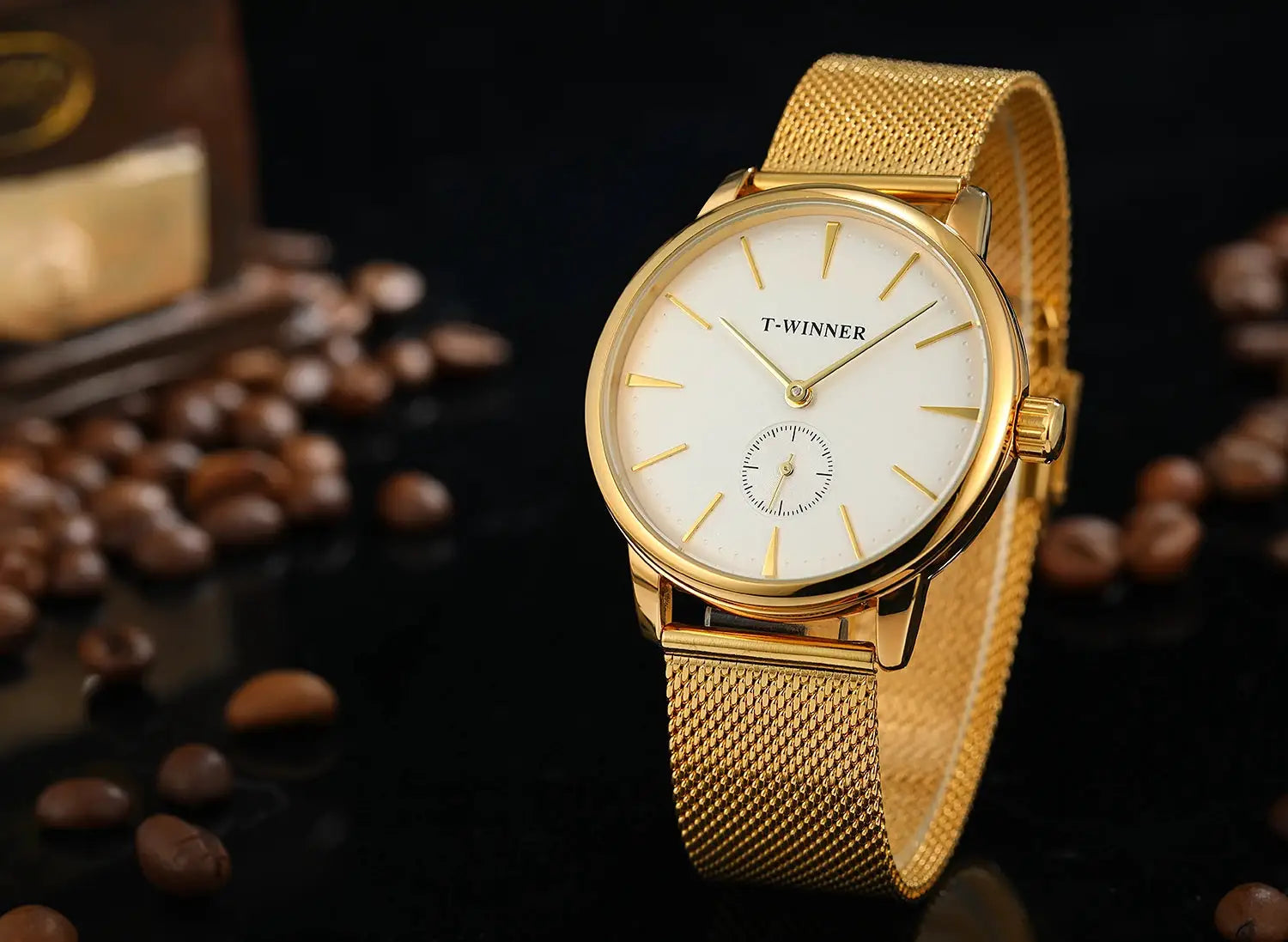 Gold-tone T-WINNER mesh-strap men's wristwatch with white dial, slim baton indices, and small seconds subdial