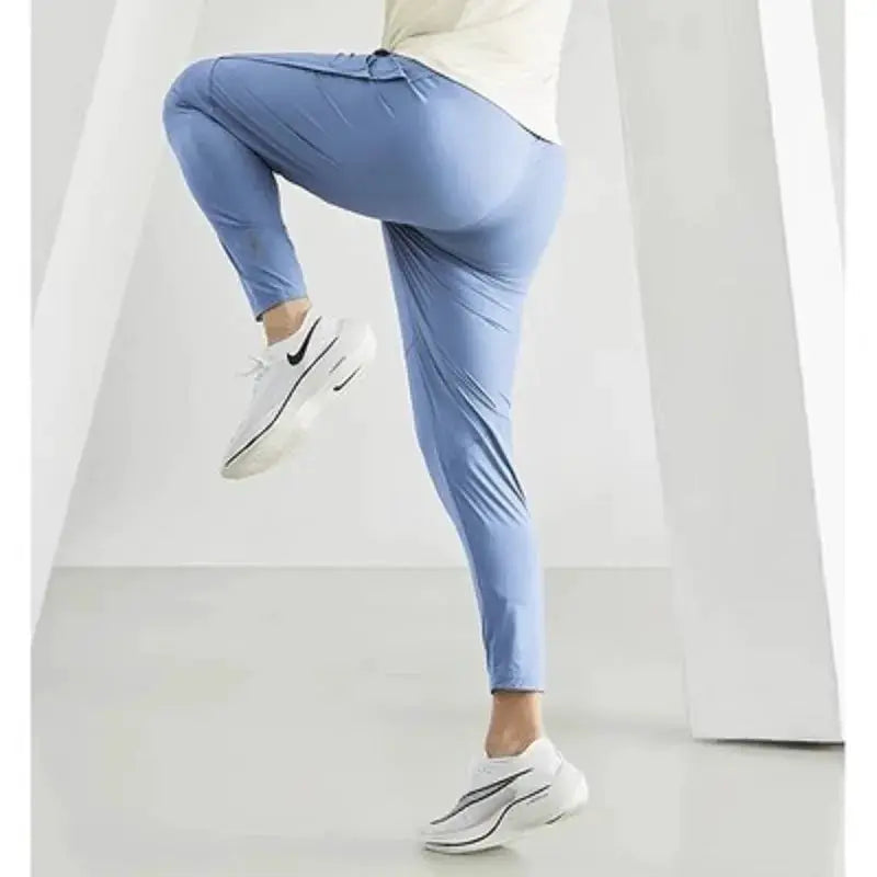 Men's running pants by Simples Market in light blue, quick-dry athletic joggers.