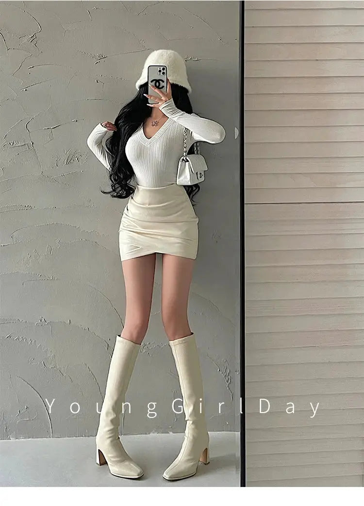Women's PU leather wrap mini skirt in ivory; high-waist A-line silhouette.