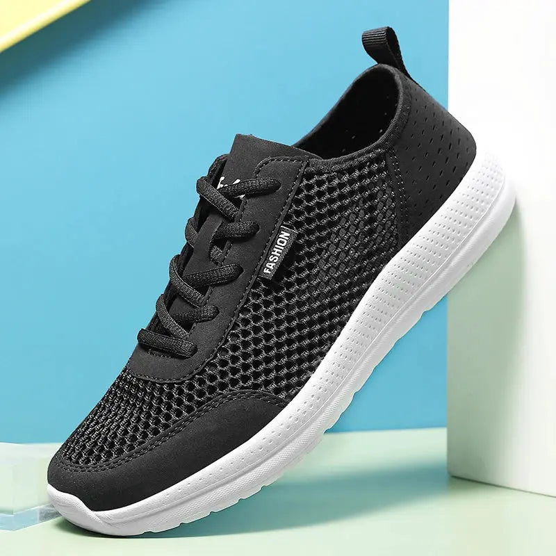 Men's breathable mesh running shoe in black with white sole and lace-up design