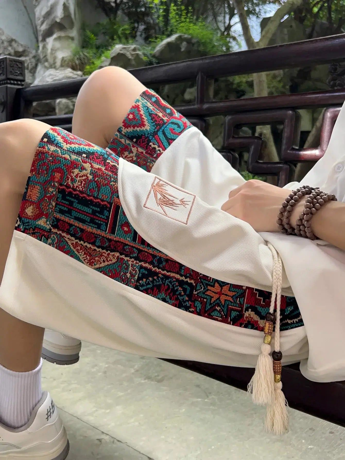 Men's ethnic embroidery shorts in white with vibrant geometric side panel, drawstring waist and pockets Simples Market