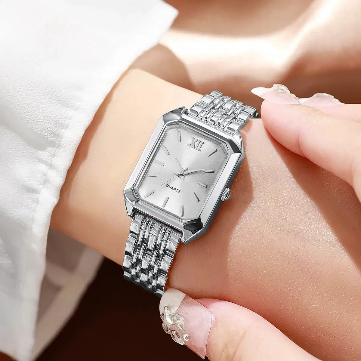 Watch: silver rectangular women's quartz timepiece with metal bracelet and Roman numeral dial
