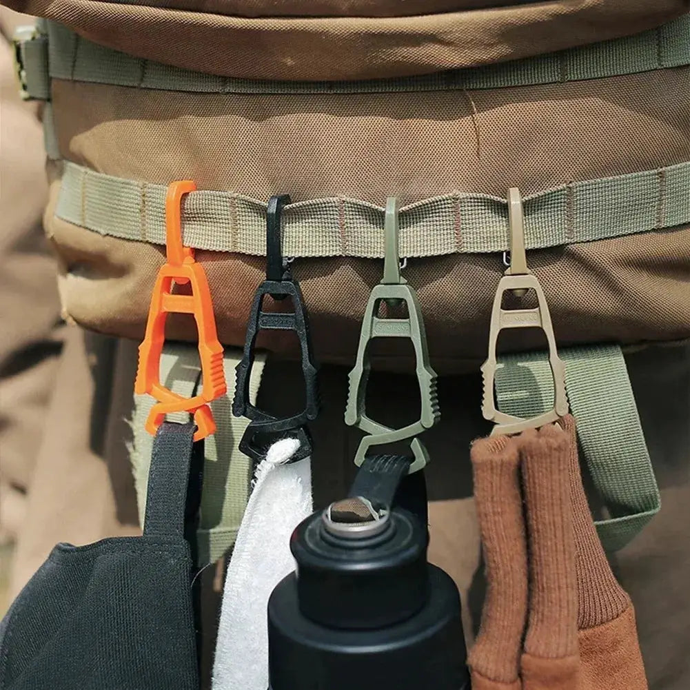 Glove clip hangers for a work belt; four color-coded clips (orange, black, olive, beige) securely hold gloves and gear.