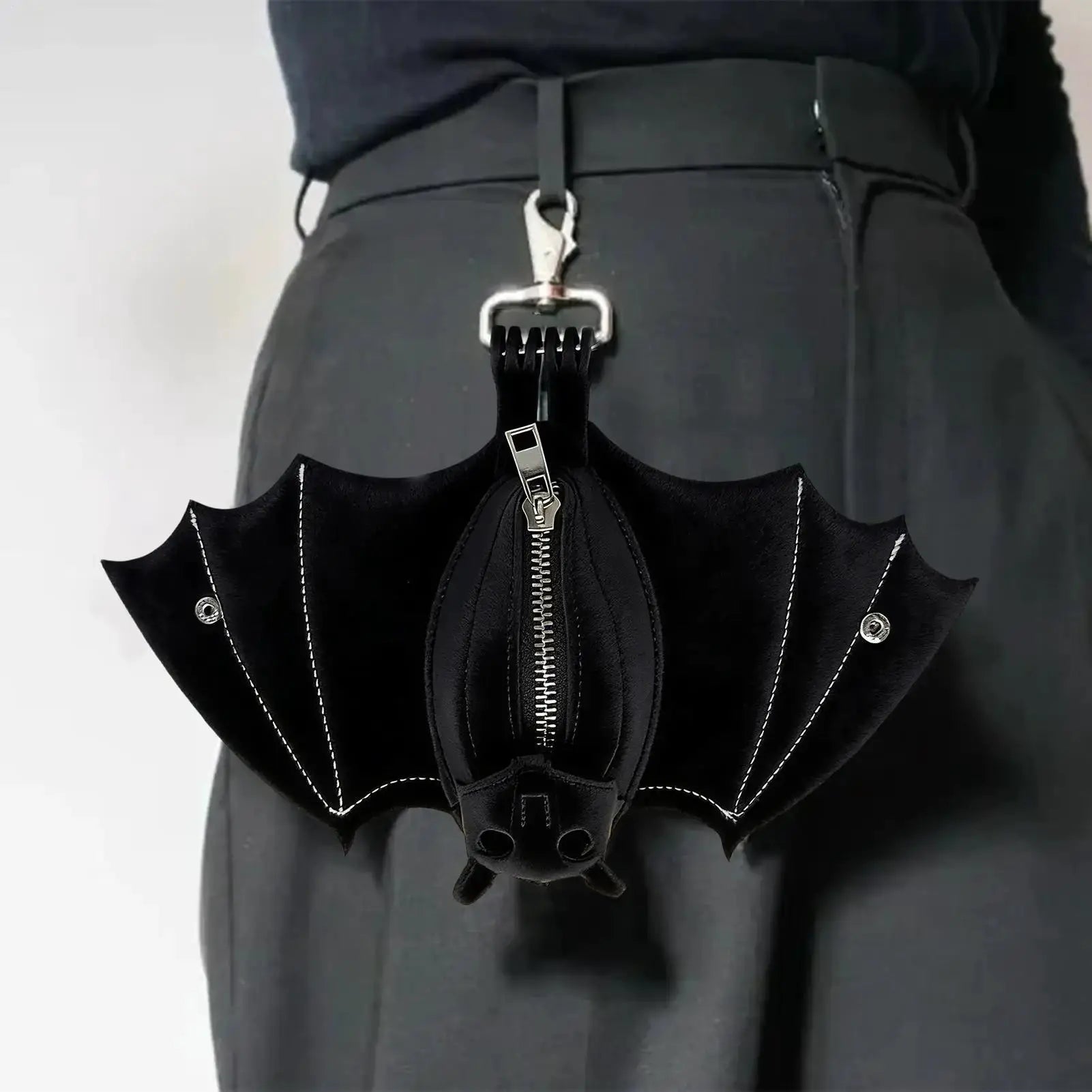 Simples Market bat-shaped PU leather coin purse with foldable wings, attached to a metal clip.
