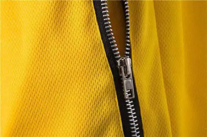 Men's yellow mesh gym shorts with zip-front, breathable quick-dry fabric.