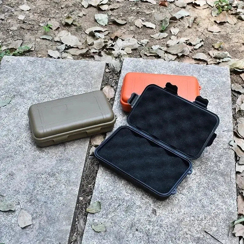Outdoor plastic waterproof sealed survival box set; 3 cases in olive, orange and black with foam-lined interiors.
