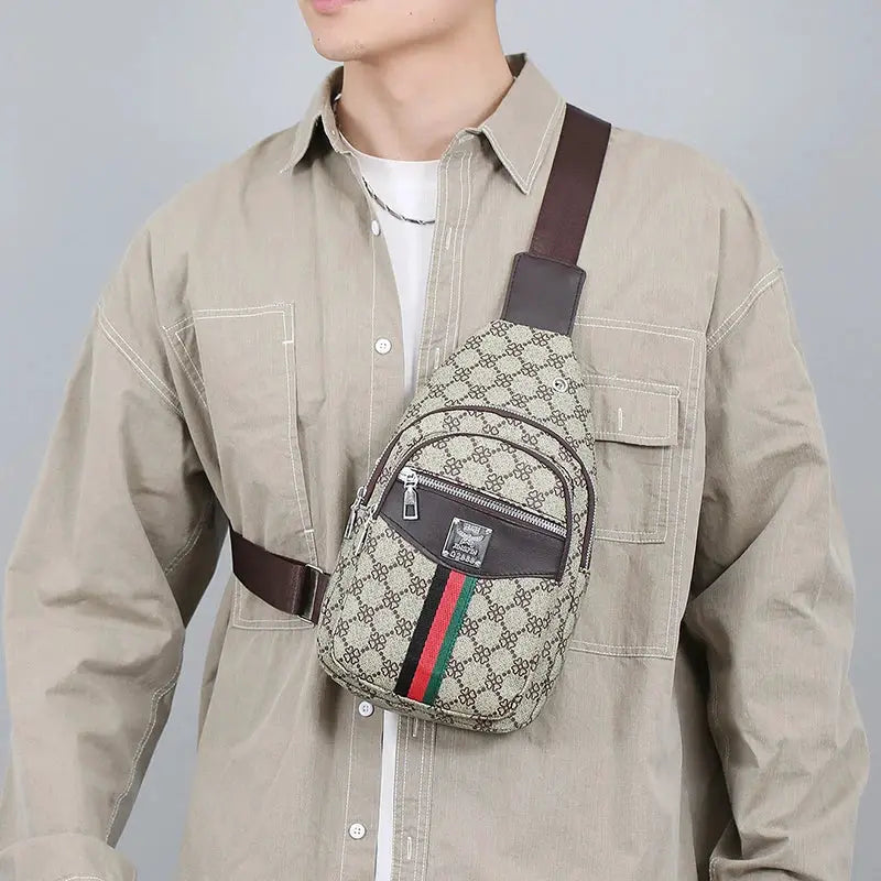 Men's crossbody messenger bag in beige monogram fabric with brown strap and green-red-green stripe.