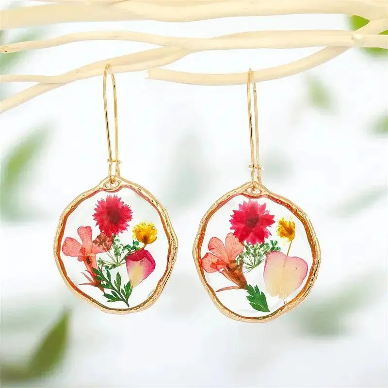 Epoxy resin flower earrings with pressed colorful blooms in gold-tone circular frames (pair)