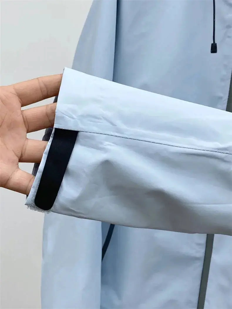 Men's outdoor windproof soft-shell jacket in light blue with adjustable Velcro cuff