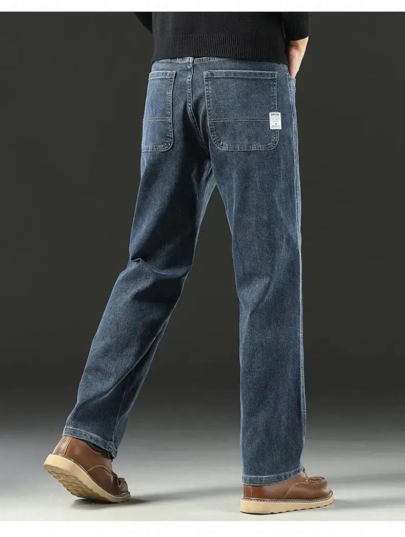 Men's baggy blue denim jeans with large back pockets and straight wide-leg cut.