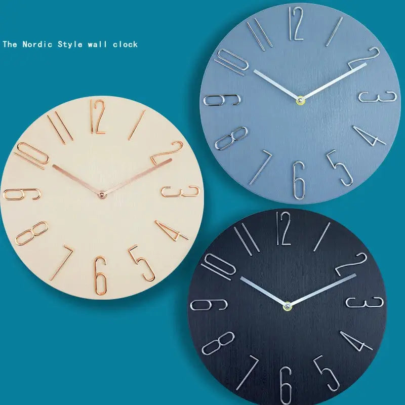 Nordic-style wall clocks set in beige, light blue, and navy with large metal numerals and no second hand
