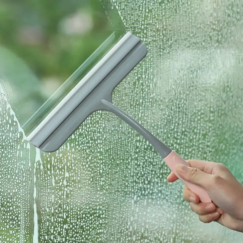 Silicone Scraper Wiper by Simples Market with pink handle and gray head for windows and glass surfaces