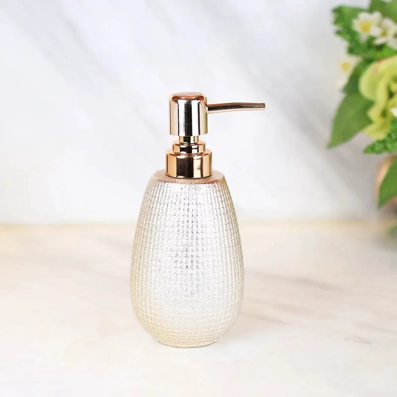 Rose gold ceramic soap dispenser with a textured pear-shaped body and metal pump