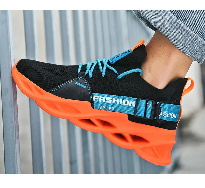 Men's sneakers with black mesh upper, turquoise laces and orange chunky sole.