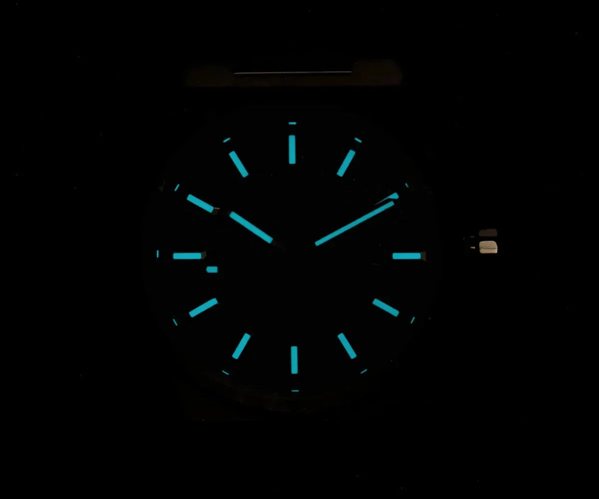 Cronos New Rhombus Perlage 39mm automatic watch with cyan luminous markers and hands on a dark dial.