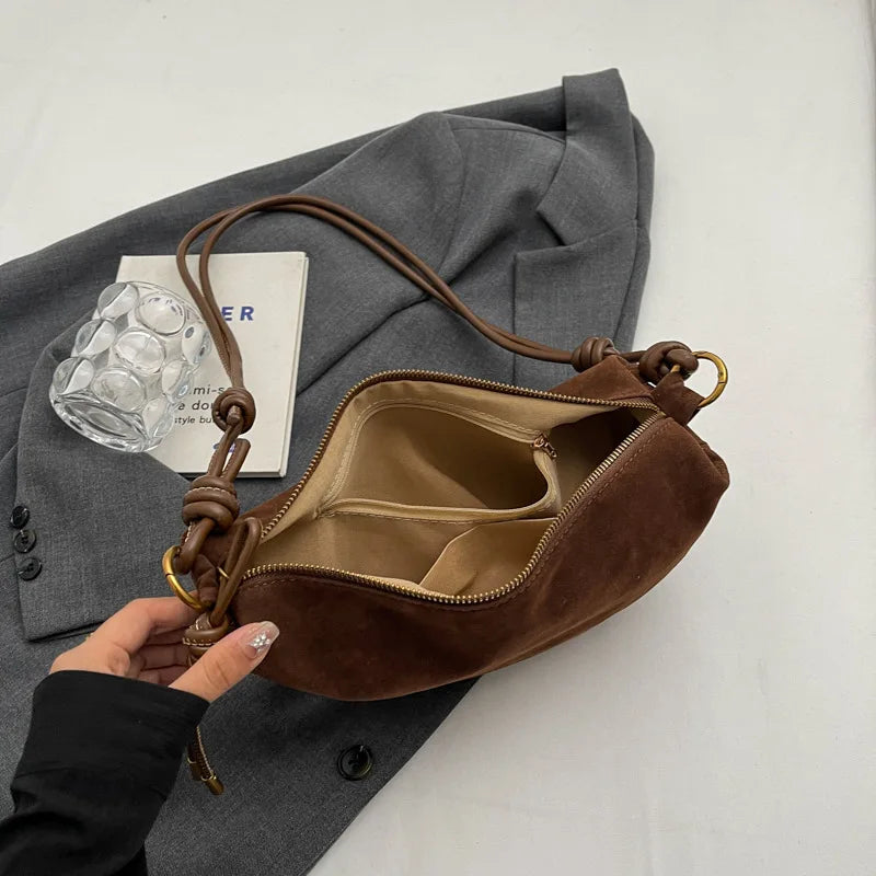 Faux suede shoulder bag in brown with tan interior, zip top and inner pocket, compact crossbody style