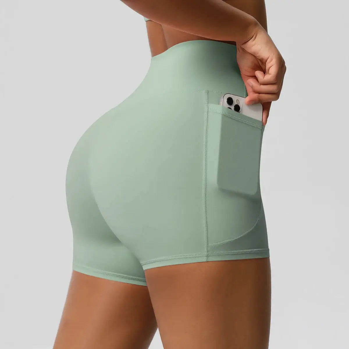 Women’s mint-green high-waist athletic shorts with side phone pocket