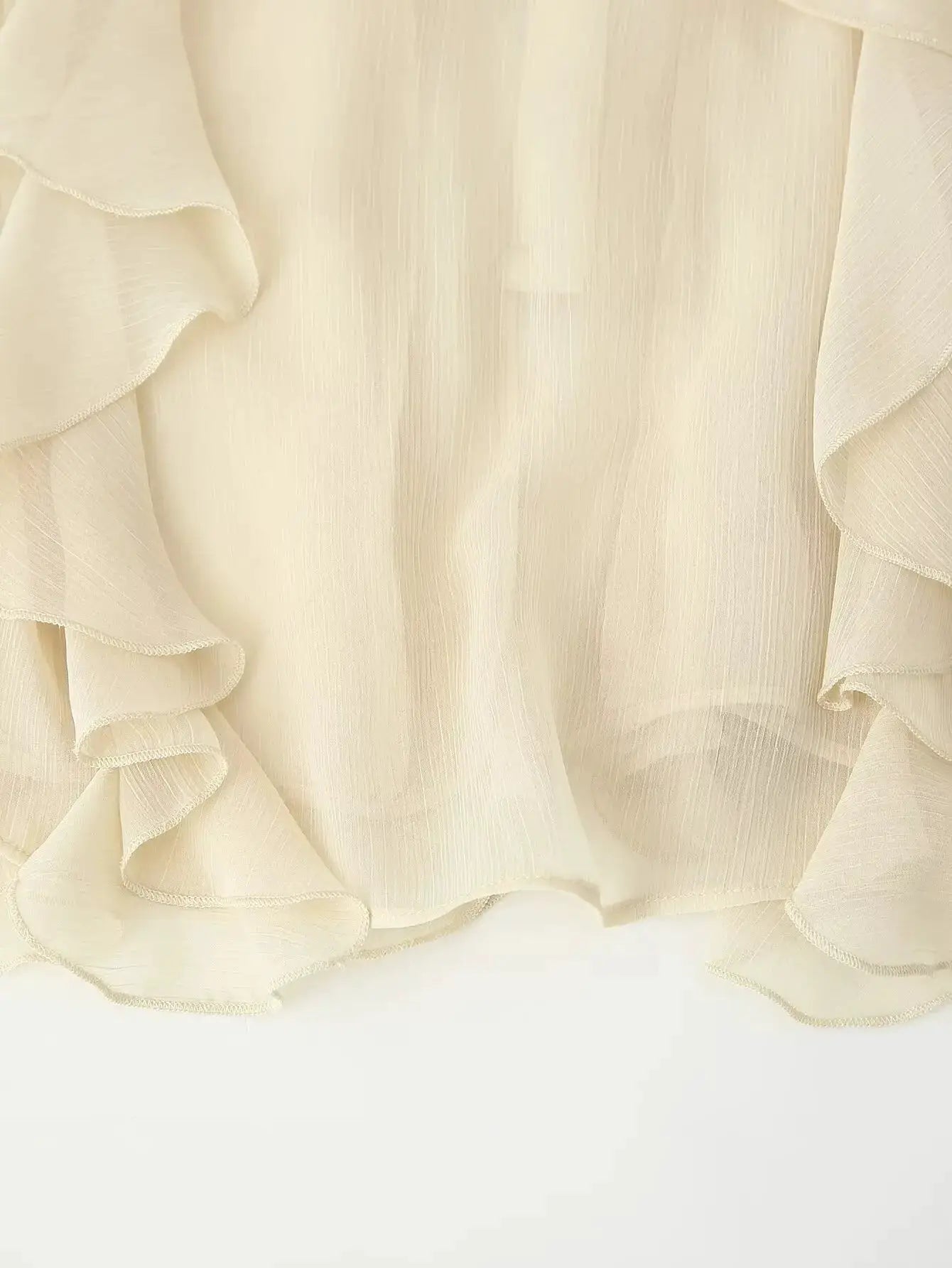 YENKYE chiffon ruffle blouse in cream fabric close-up.