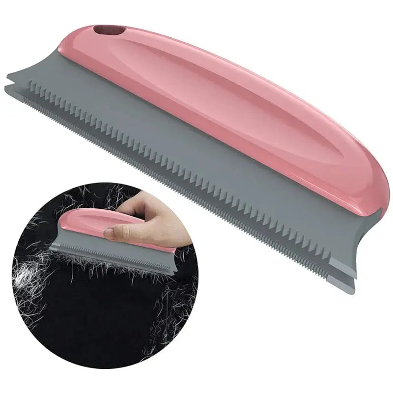 Lint hair remover brush for sofas and fabrics, pink ergonomic handle with gray serrated blade.