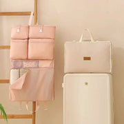 Business Travel Storage Hanging Bag by Simples Market, pink foldable organizer with multiple pockets.