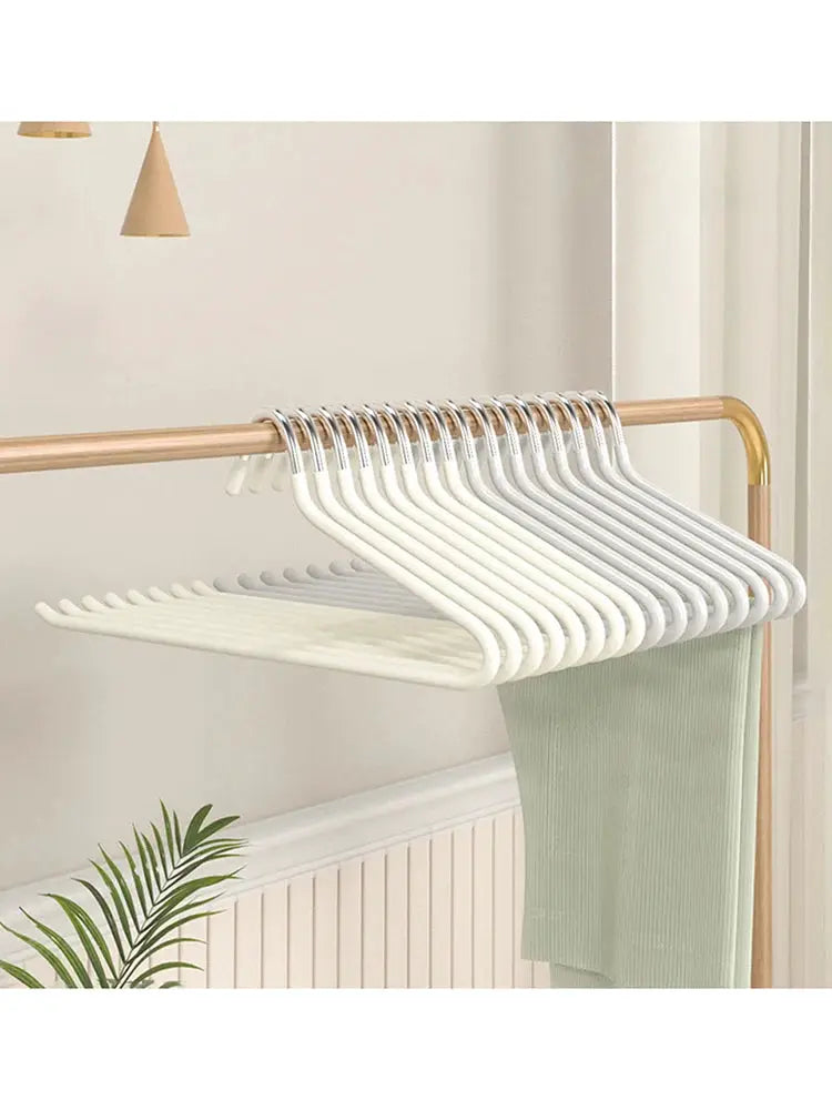 Goose-shaped pants hangers set of 30, white plastic with metal hooks on a wooden clothing rack.
