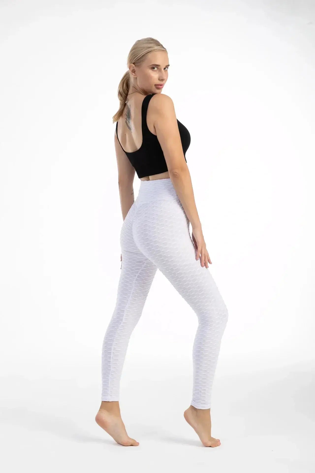 Women's white high-waist bubble-textured leggings for yoga and gym, seamless and form-fitting