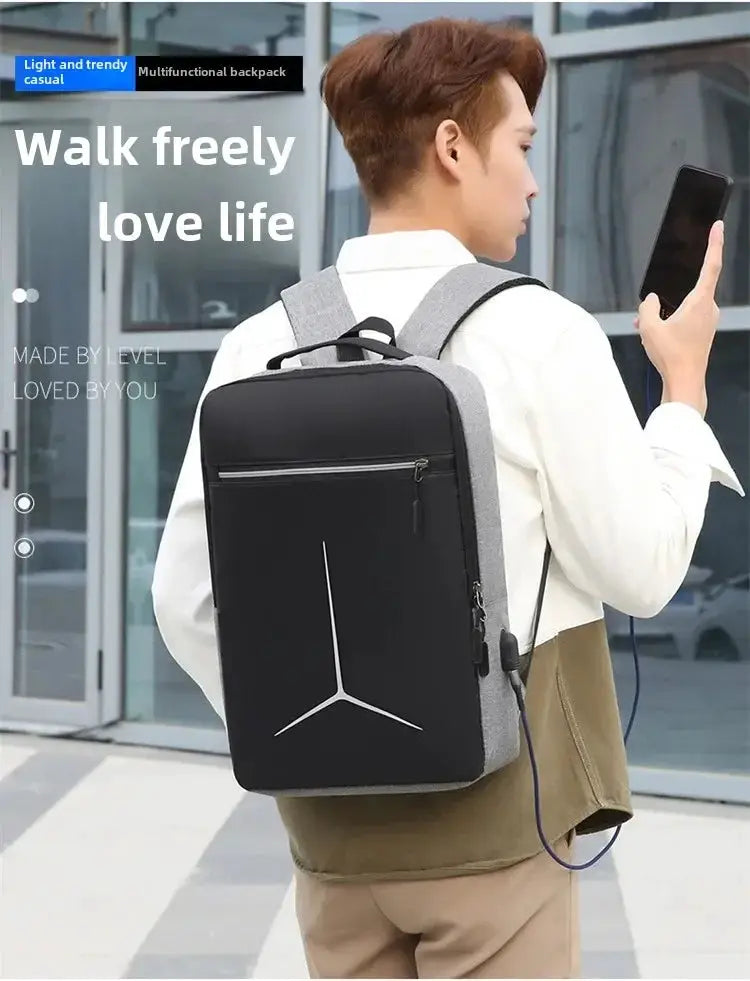 Smart laptop backpack in black with gray sides and a front zip pocket, worn by a man