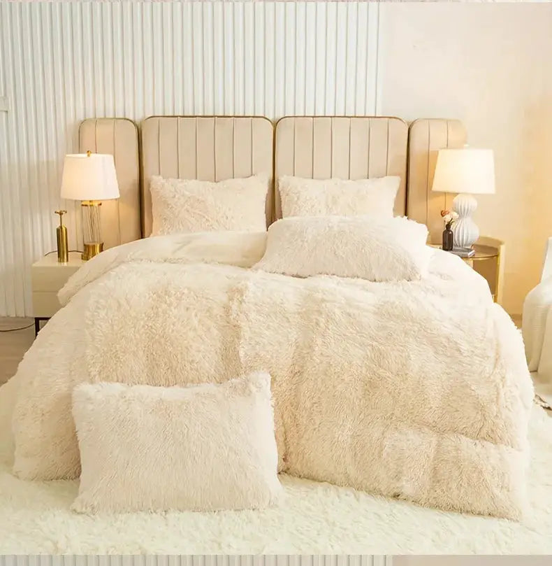 3-Piece plush ivory duvet cover set with matching shams on a cream upholstered bed