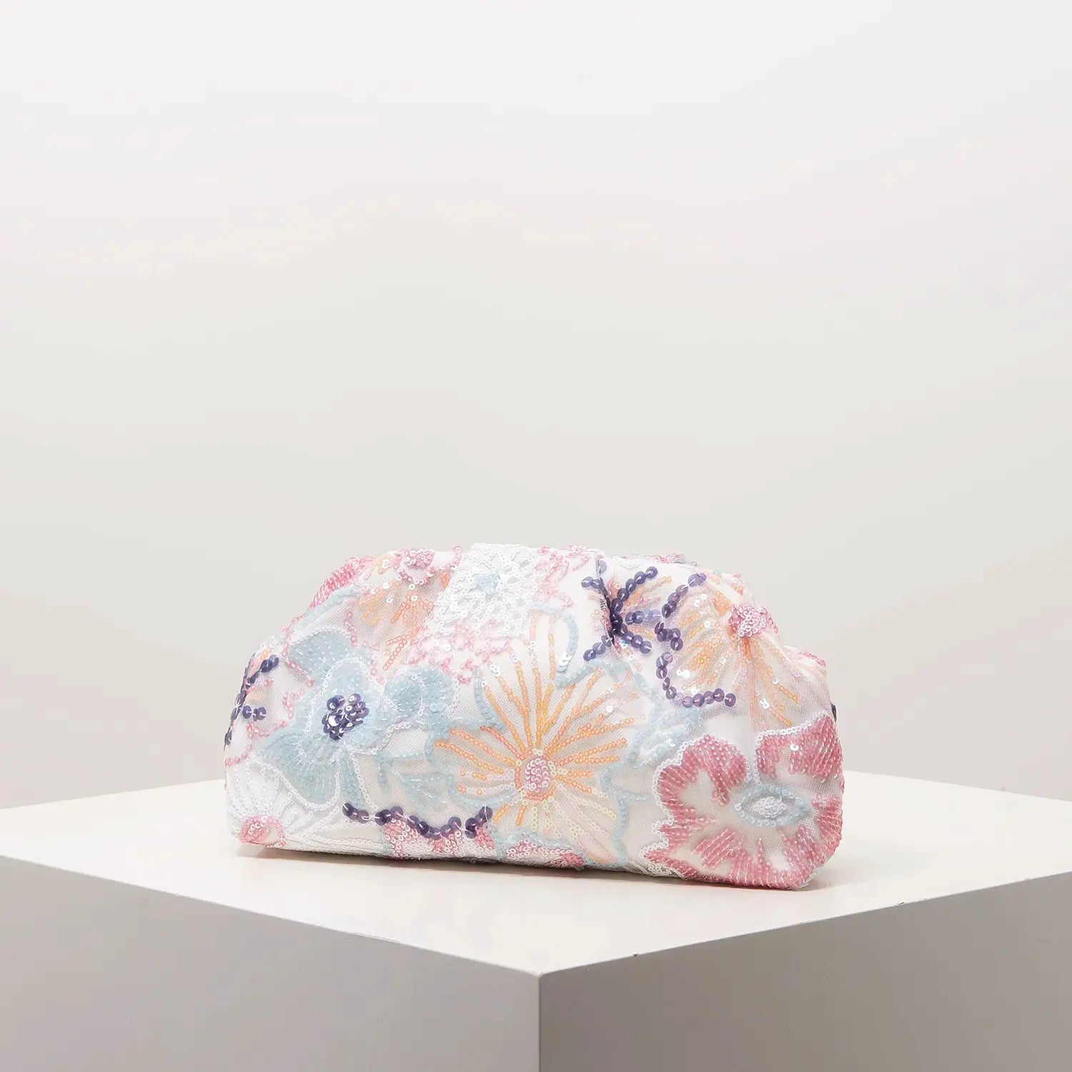 Clutch bag with pastel sequin floral embroidery on white fabric for gala nights