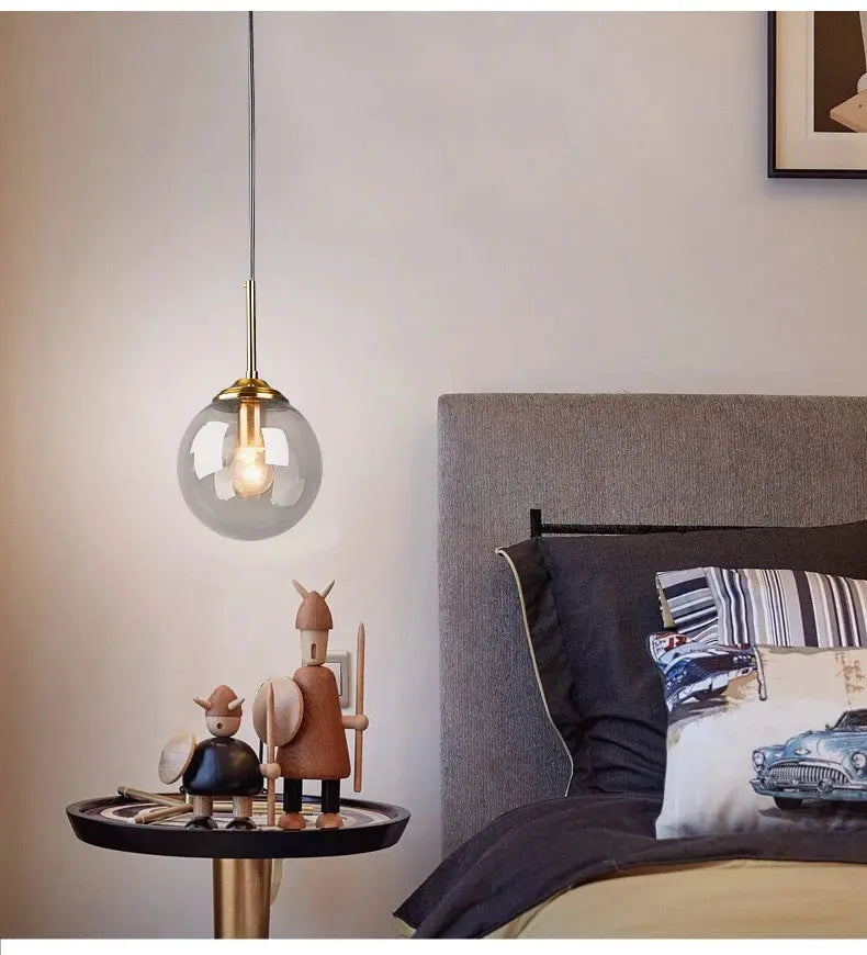 Modern glass globe pendant lamp with brass cap and hanging cord, Nordic LED chandelier for living room and dining room.