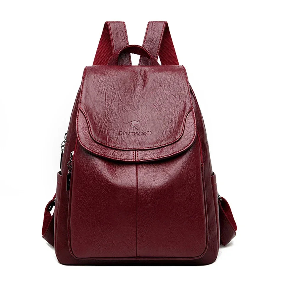 Genuine women's soft leather backpack in burgundy red with flap front pocket and adjustable straps
