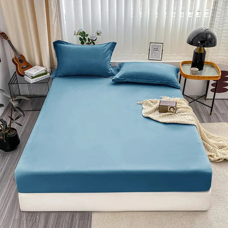 Fitted blue bed sheet with elastic edges; anti-slip, adjustable mattress cover for single to king beds.