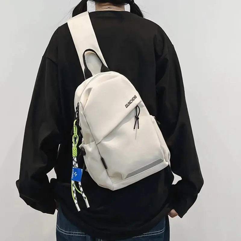Lightweight crossbody tablet bag worn by a person from behind, featuring a sleek design and adjustable strap.
