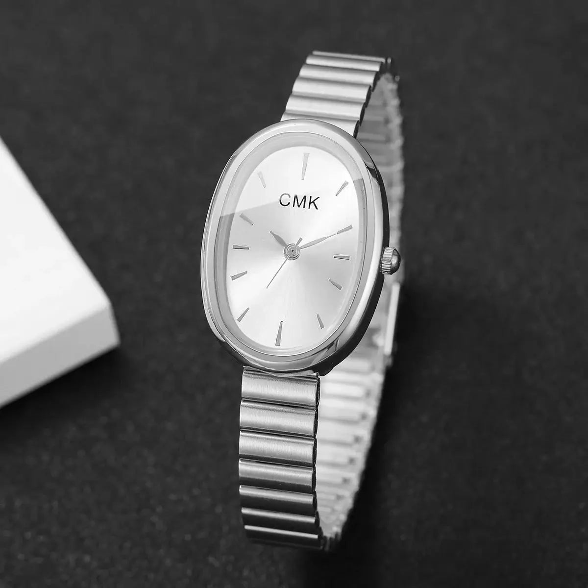 Oval-dial women's quartz wristwatch with silver metal bracelet and CMK logo