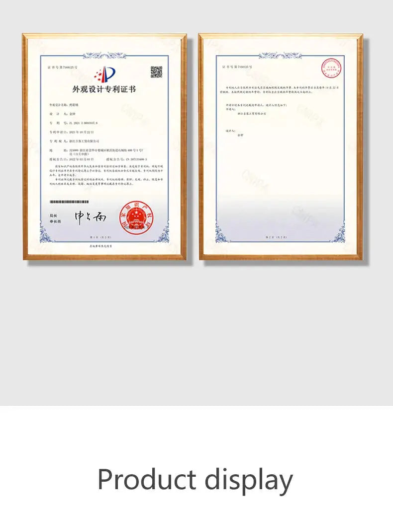 Two framed certificates in gold-tone frames hanging on a light gray wall.