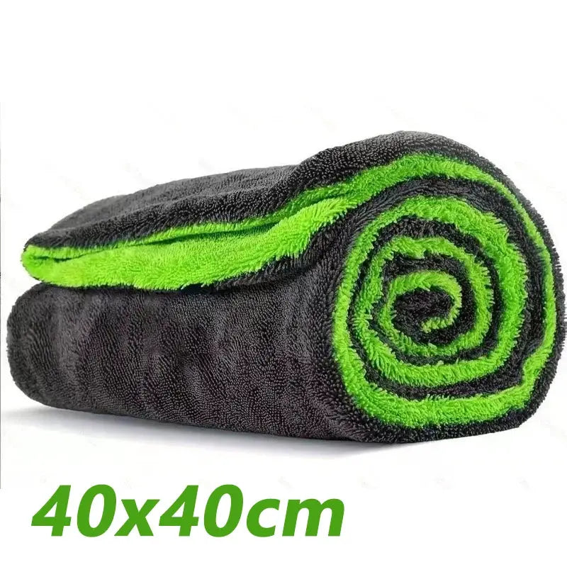 Car drying towel, oversized black microfiber with lime-green trim, rolled for storage