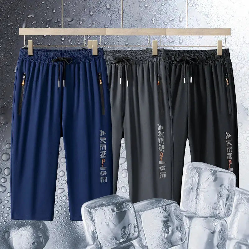 Three men's elastic-waist sports shorts in blue, gray, and black with quick-dry breathable fabric