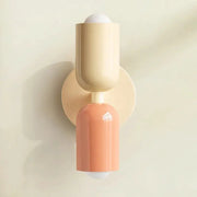 Nordic LED wall lamp with dual cream and peach cylindrical heads, modern minimalist fixture for living room or bedroom