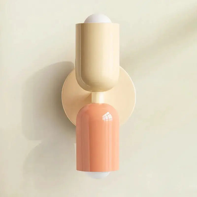 Nordic LED wall lamp with dual cream and peach cylindrical heads, modern minimalist fixture for living room or bedroom